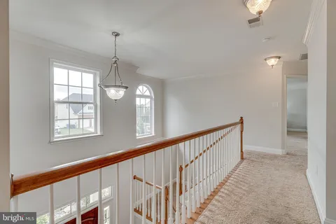 a spacious bedroom with a bed and a ceiling fan