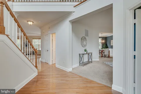 a living room with furniture a clock and a window