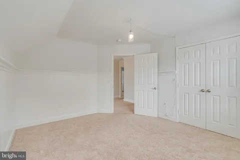 a view of a white house with a yard and plants