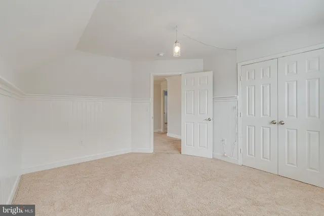a view of a white house with a yard and plants