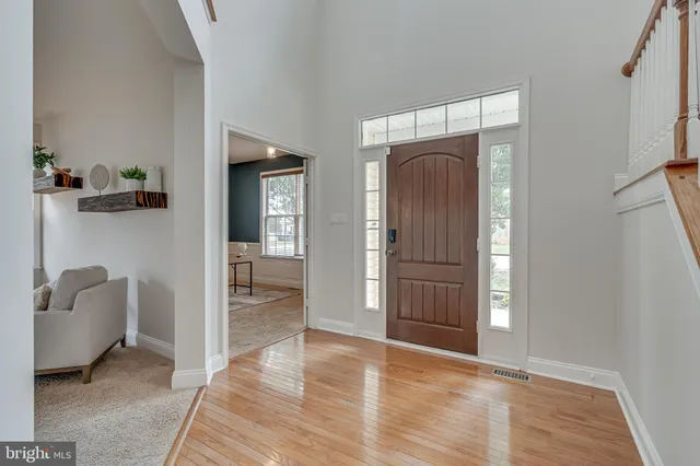 a view of entryway and hall with wooden floor