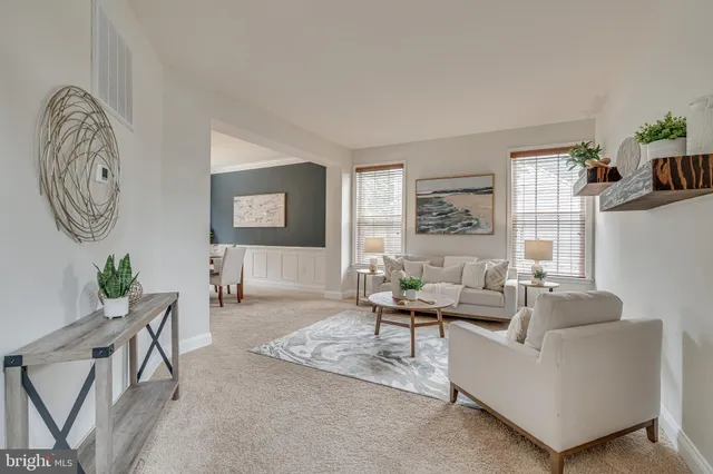 a living room with furniture a chandelier and a large window