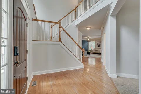 a living room with furniture a fireplace and a large window