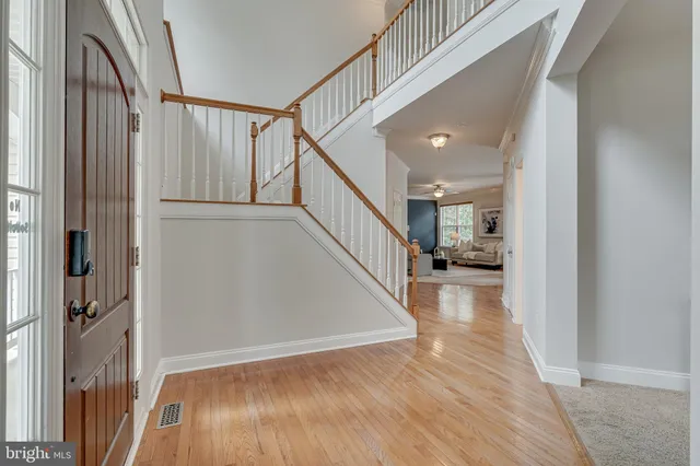 a living room with furniture a fireplace and a large window