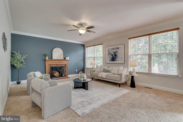 a dining room with stainless steel appliances granite countertop a stove top oven a refrigerator with a dining table and chairs