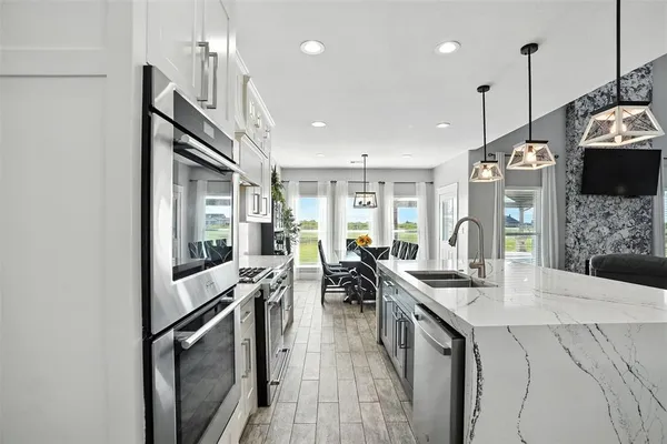 a view of a kitchen and living room with windows