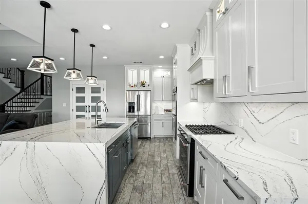 a kitchen with lot of cabinets and black appliances