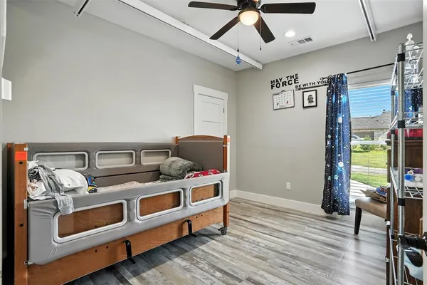 a bedroom with furniture and a ceiling fan