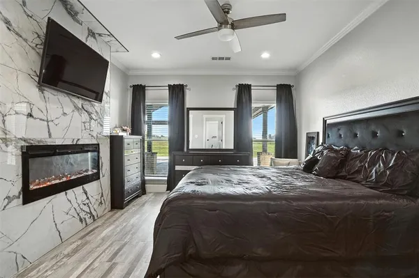a bed room with a bed a television and a fireplace