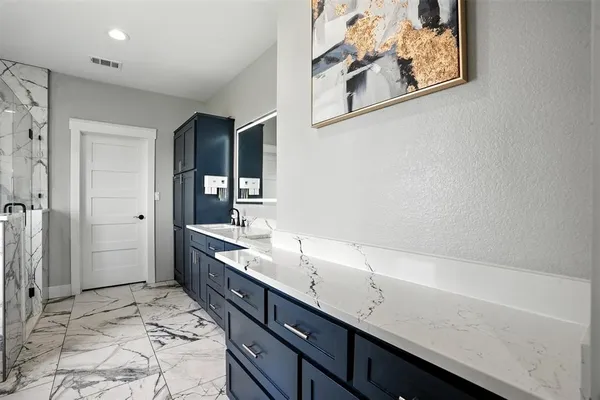 a spacious bathroom with a sink and a mirror