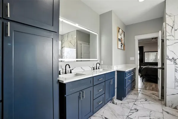 a bathroom with a double vanity sink and a mirror