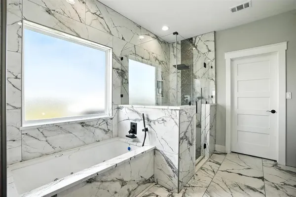 a bathroom with a bathtub and a shower