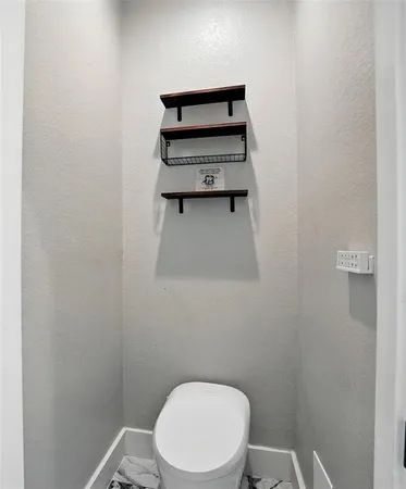 a white toilet sitting next to a white sink