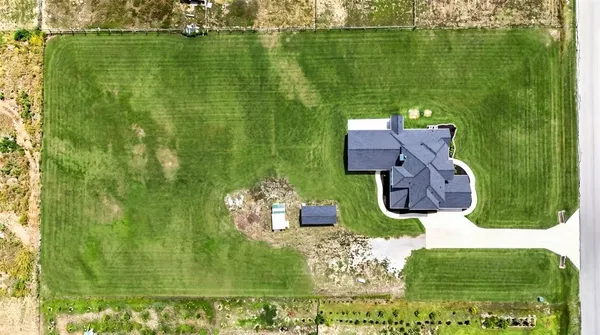 an aerial view of a residential houses with outdoor space