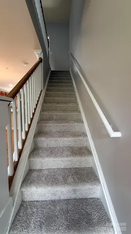 an empty room with fan and windows