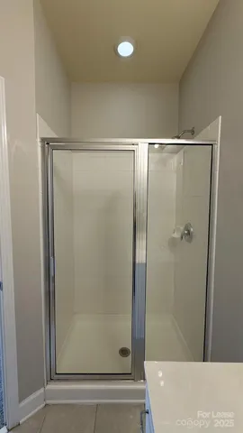 an empty room with a ceiling fan and window