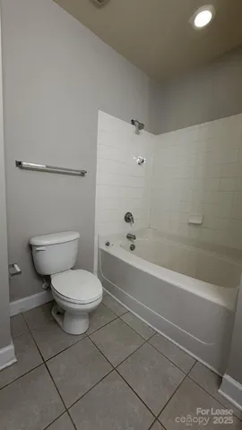 an empty room with closet and a ceiling fan