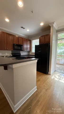 a kitchen with stainless steel appliances granite countertop a stove top oven a sink dishwasher and a refrigerator