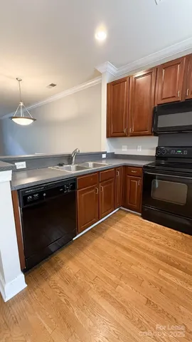 a kitchen with wooden cabinets and a sink