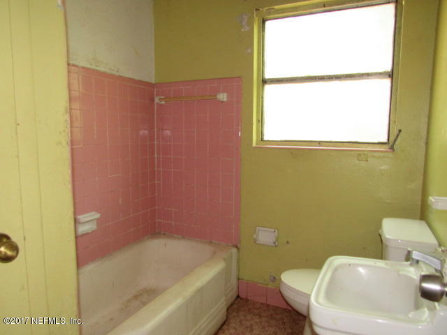 7008 Rollo Road Jacksonville, FL 32205 - Photo 13 of 14 a bathroom with a sink and bathtub with toilet