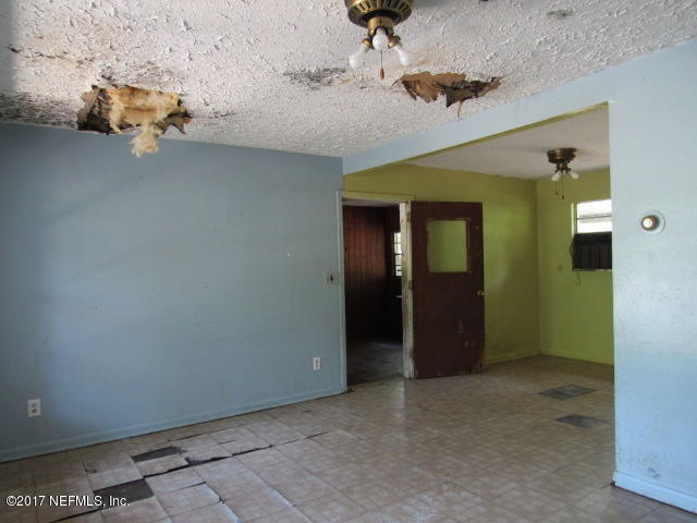 7008 Rollo Road Jacksonville, FL 32205 - Photo 5 of 14 an empty room with windows