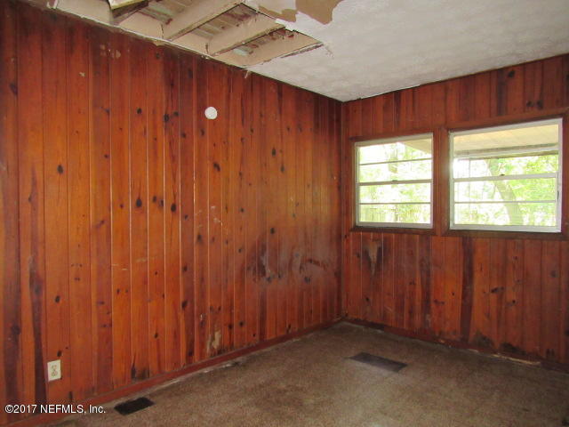 7008 Rollo Road Jacksonville, FL 32205 - Photo 7 of 14 an empty room with windows