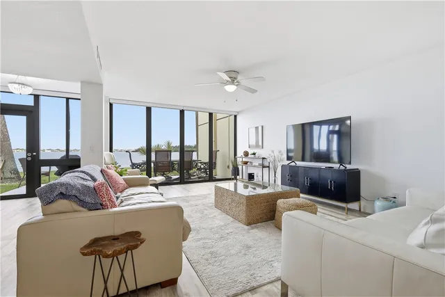 a living room with furniture and a floor to ceiling window