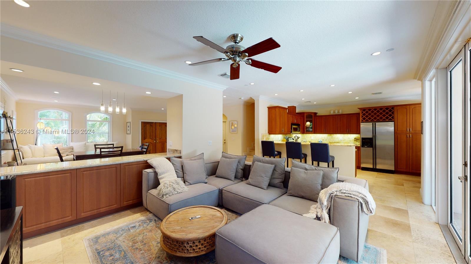 3060 Indiana Street, Unit 3060 Coconut Grove, FL 33133 - Photo 16 of 52 a living room with furniture a kitchen view and a chandelier