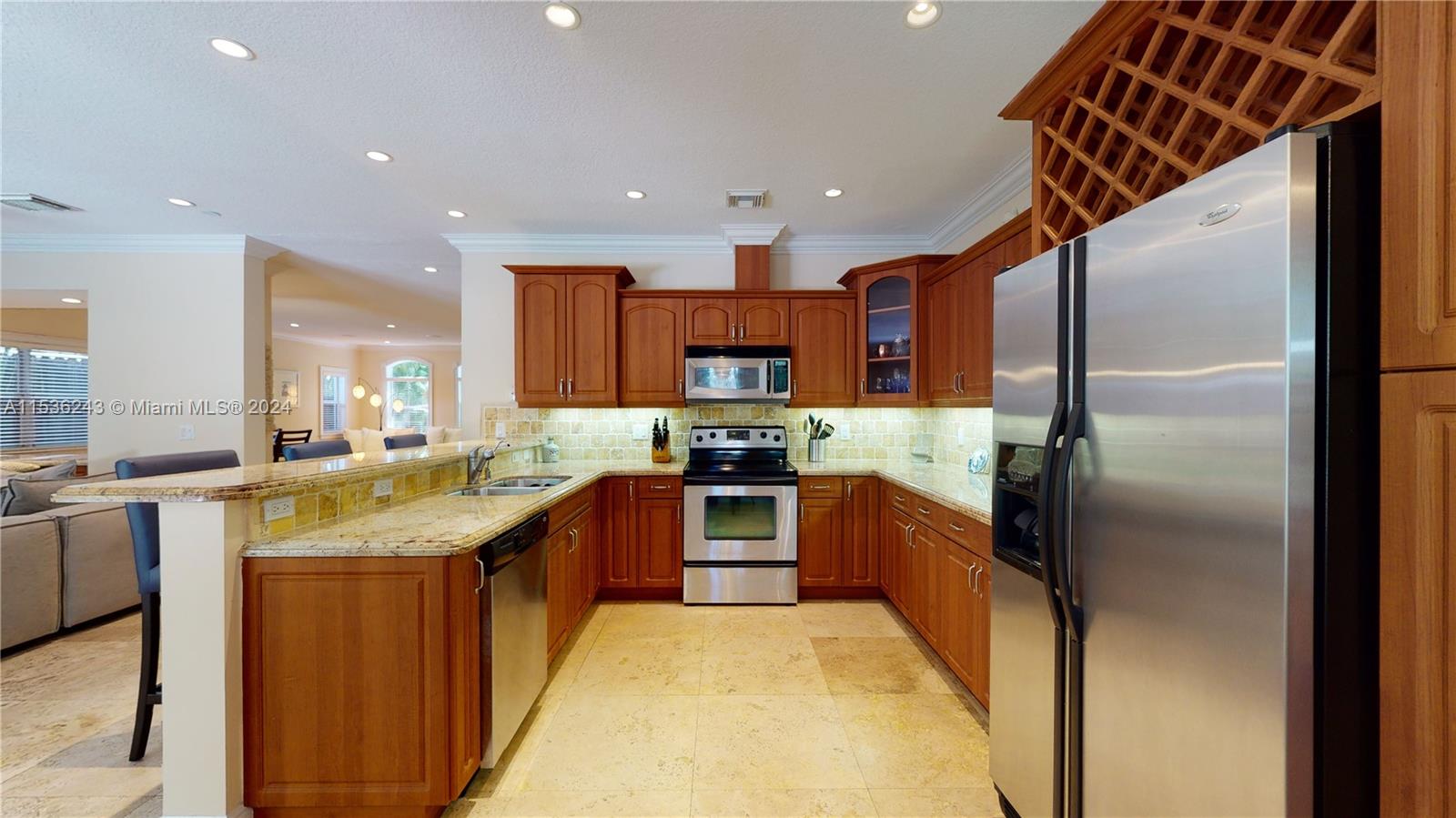 3060 Indiana Street, Unit 3060 Coconut Grove, FL 33133 - Photo 18 of 52 a large kitchen with stainless steel appliances granite countertop a sink and a refrigerator