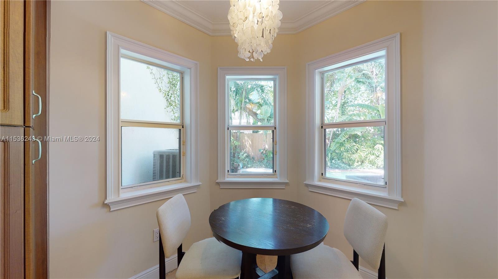 3060 Indiana Street, Unit 3060 Coconut Grove, FL 33133 - Photo 19 of 52 a room that has a window and a chandelier