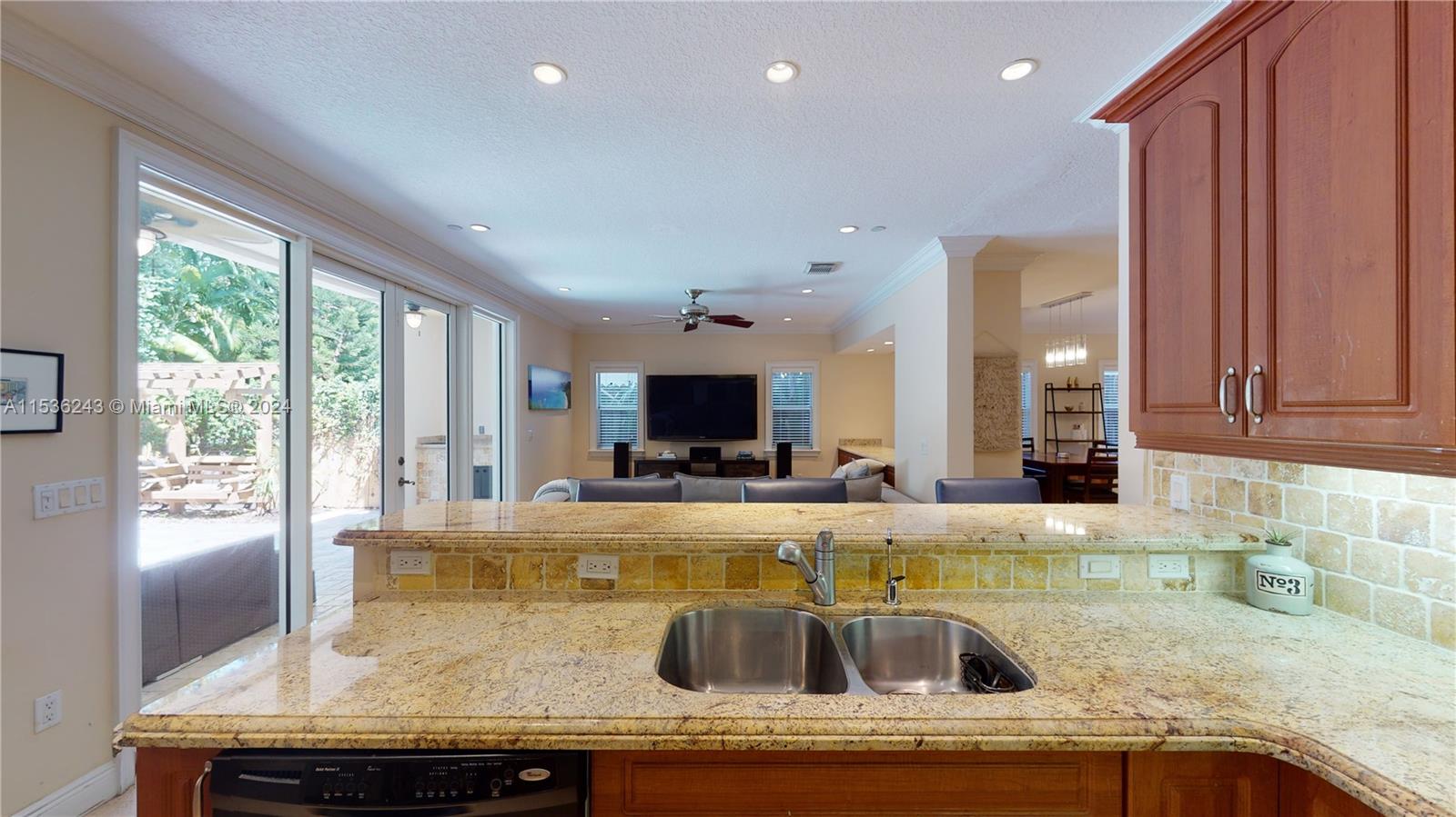 3060 Indiana Street, Unit 3060 Coconut Grove, FL 33133 - Photo 21 of 52 a kitchen with kitchen island granite countertop a sink and a large window