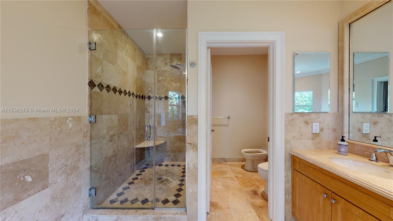 3060 Indiana Street, Unit 3060 Coconut Grove, FL 33133 - Photo 38 of 52 a bathroom with a granite countertop sink mirror and a shower