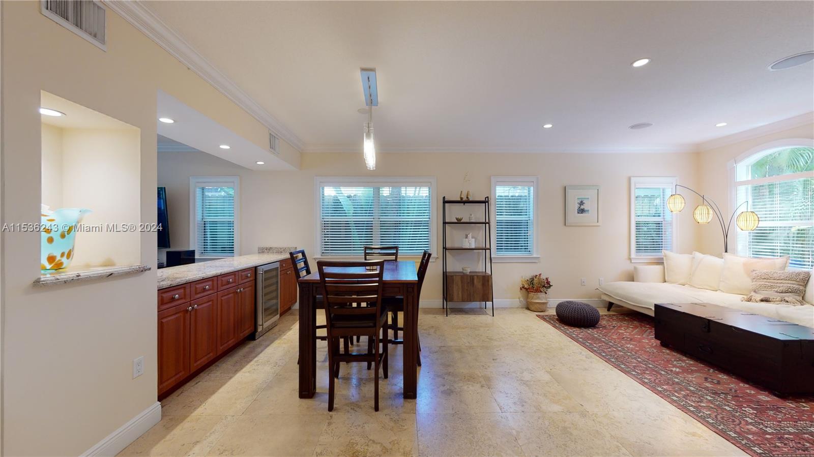 3060 Indiana Street, Unit 3060 Coconut Grove, FL 33133 - Photo 4 of 52 a large kitchen with kitchen island a sink a table and chairs