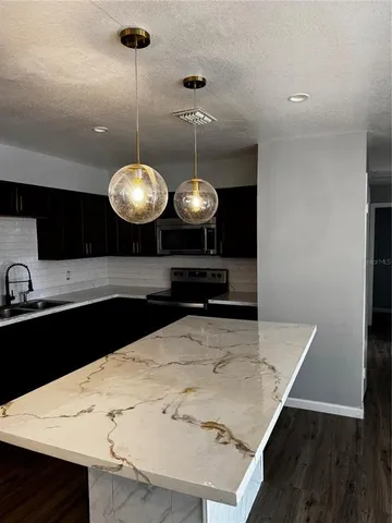 a kitchen with a table and a refrigerator