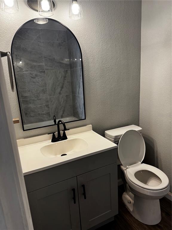 409 Fern Road Winter Haven, FL 33880 - Photo 17 of 21 a bathroom with a toilet a sink and mirror