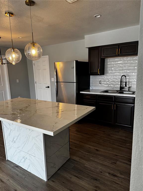409 Fern Road Winter Haven, FL 33880 - Photo 19 of 21 a kitchen with kitchen island granite countertop a sink a counter space appliances and cabinets