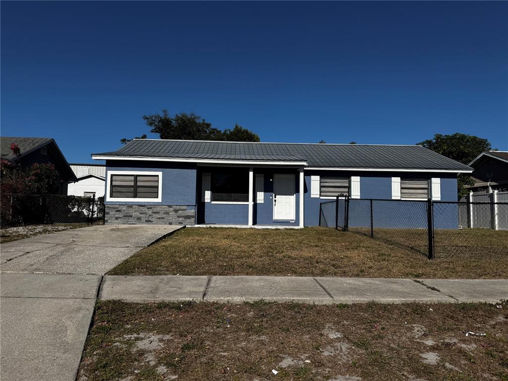 409 Fern Road Winter Haven, FL 33880 - Photo 2 of 21 a front view of a house with a garden