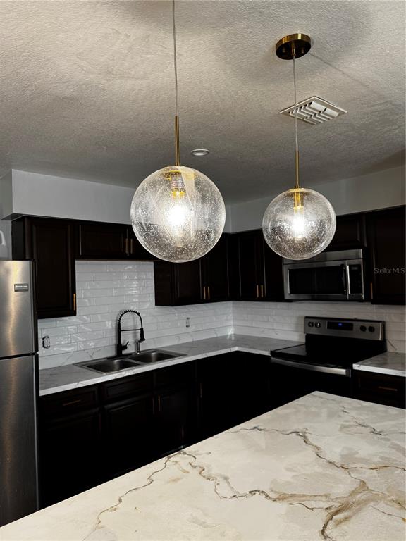 409 Fern Road Winter Haven, FL 33880 - Photo 5 of 21 a kitchen with a refrigerator a sink and cabinets