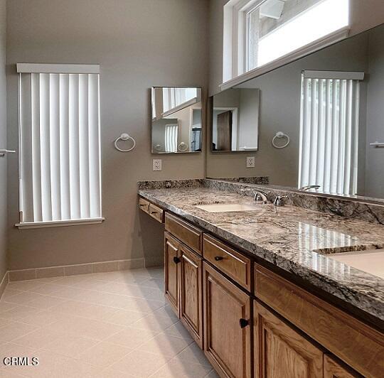 26963 Calamine Drive Calabasas, CA 91301 - Photo 20 of 31 a bathroom with a granite countertop sink and a mirror