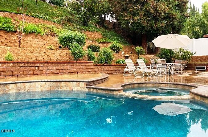 26963 Calamine Drive Calabasas, CA 91301 - Photo 27 of 31 a view of a swimming pool with a yard