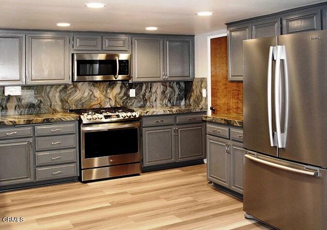 26963 Calamine Drive Calabasas, CA 91301 - Photo 8 of 31 a kitchen with stainless steel appliances granite countertop a refrigerator and a stove