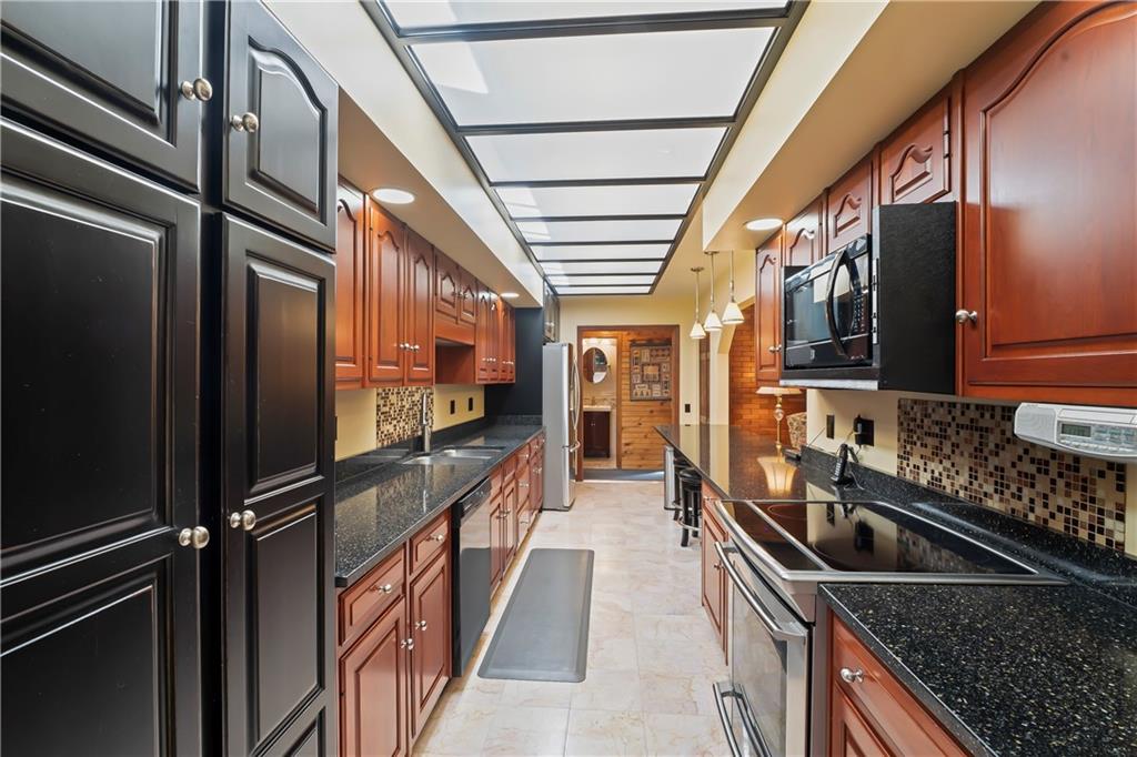 143 Lynn Road Washington, PA 15301 - Photo 11 of 25 a kitchen with granite countertop a sink and stainless steel appliances