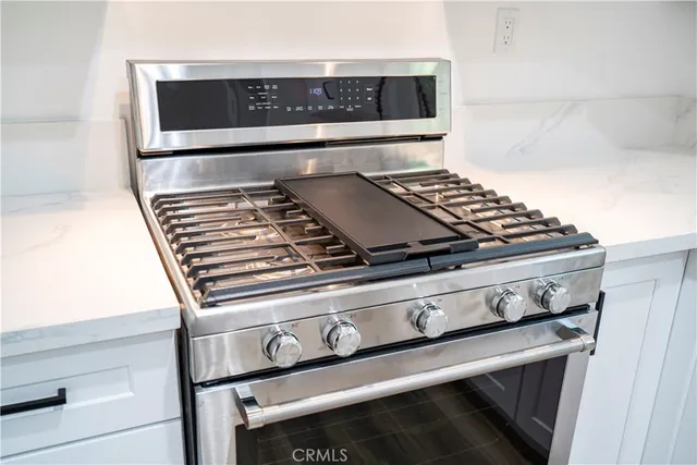 a stove top oven sitting inside of a kitchen