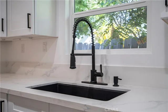 a kitchen with a sink and large window