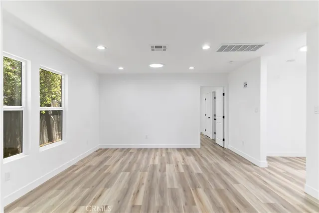 a view of room with window and hardwood floor