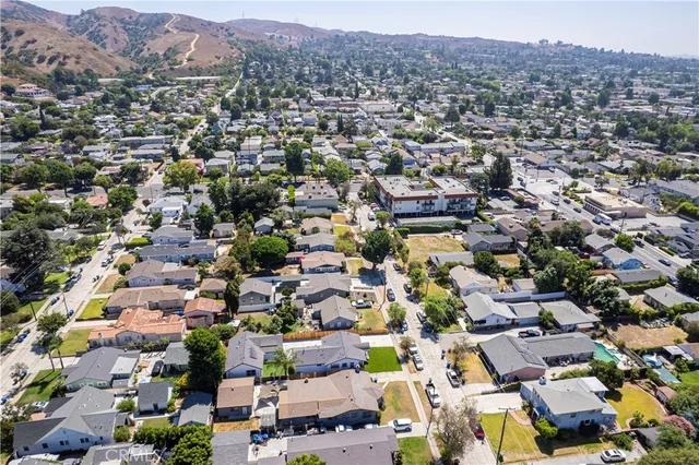 an aerial view of residential houses with outdoor space