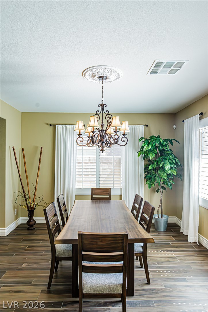 75 Tall Ruff Drive Las Vegas, NV 89148 - Photo 10 of 64 Elegant wood-look flooring sets a warm tone in this inviting formal dining room.