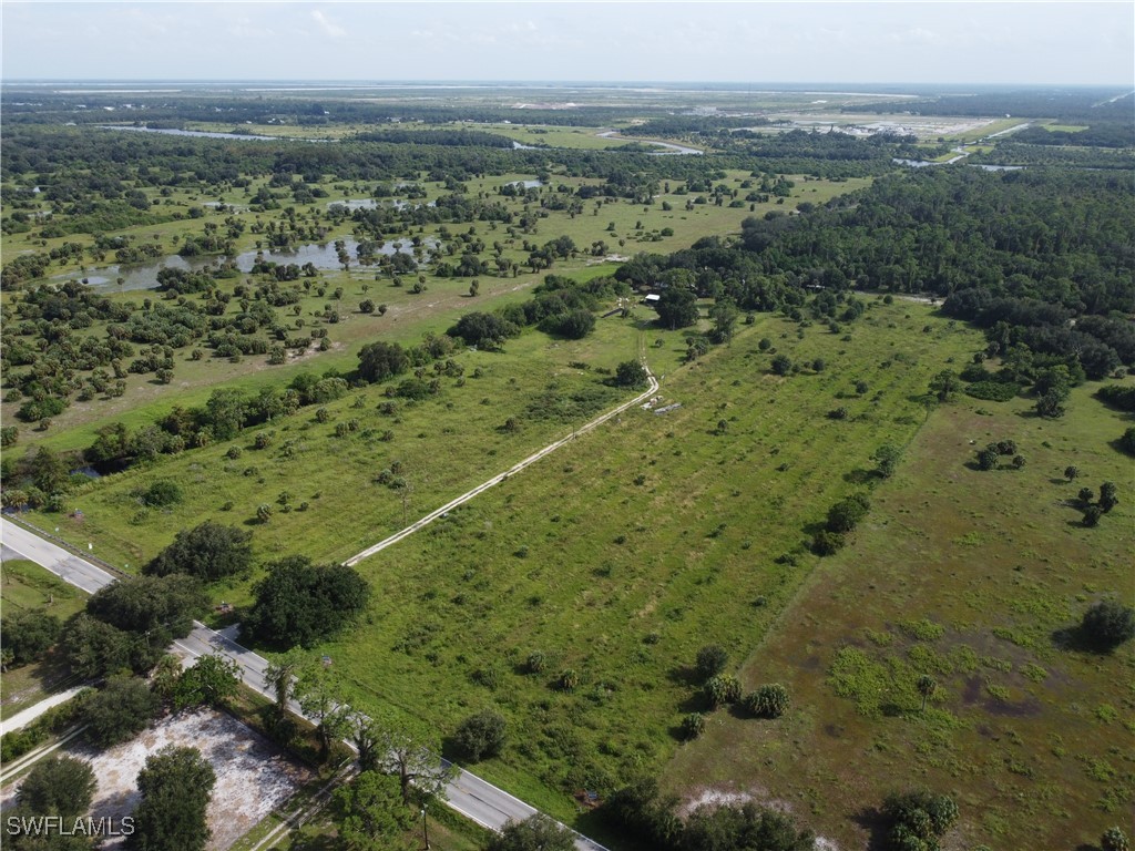 23960 North River Road Alva, FL 33920 - Photo 14 of 17 a view of a green field with lots of trees