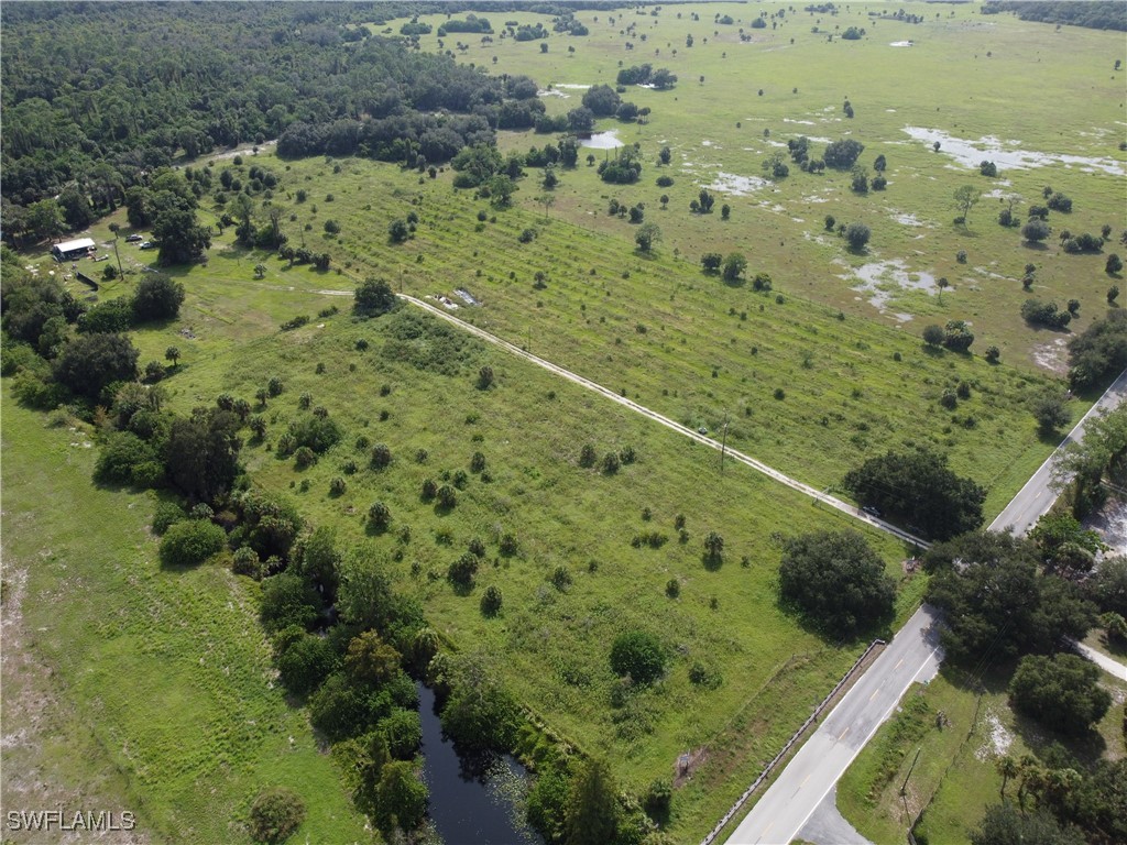 23960 North River Road Alva, FL 33920 - Photo 9 of 17 a view of a forest with a houses