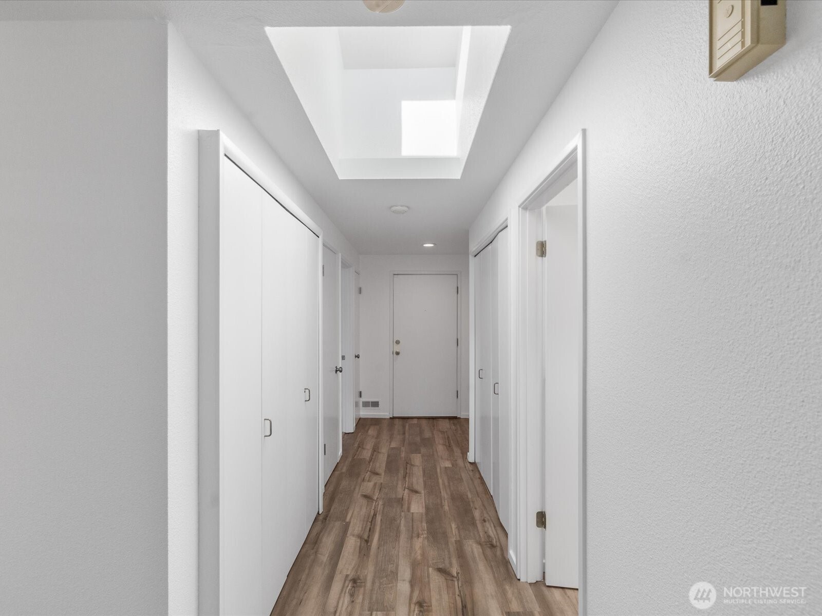8225 212th Street Southwest, Unit 302 Edmonds, WA 98026 - Photo 11 of 16 a view of a hallway with wooden floor and staircase